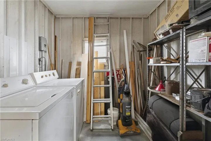 Laundry area with concrete flooring and washing machine and dryer