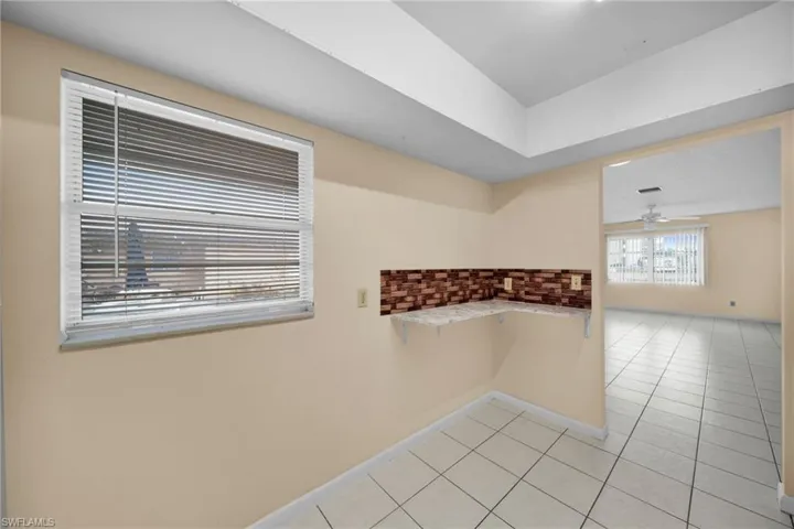 Spare room with light tile patterned flooring and a ceiling fan