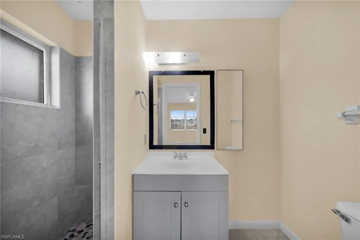Full bath featuring vanity and a stall shower