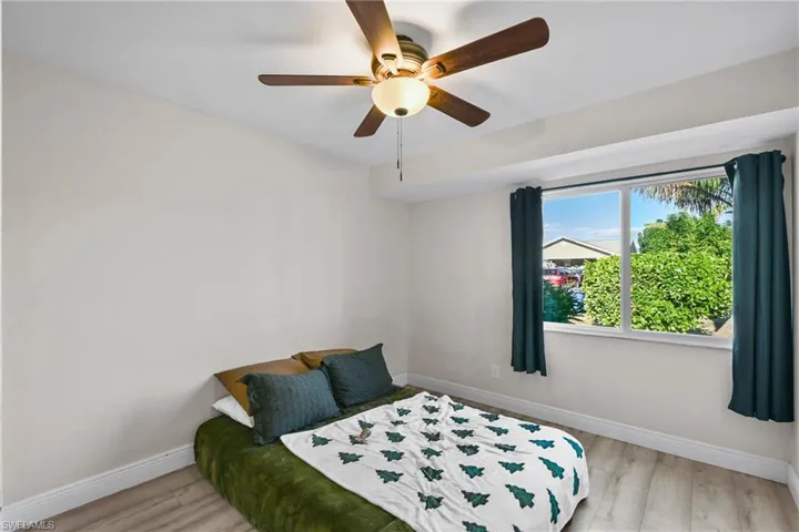 Bedroom featuring a ceiling fan and light wood-type flooring
