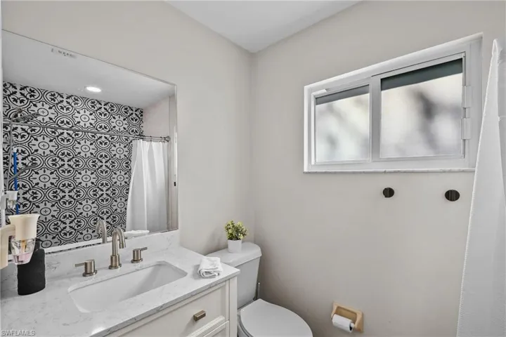 Bathroom with vanity and a shower with shower curtain
