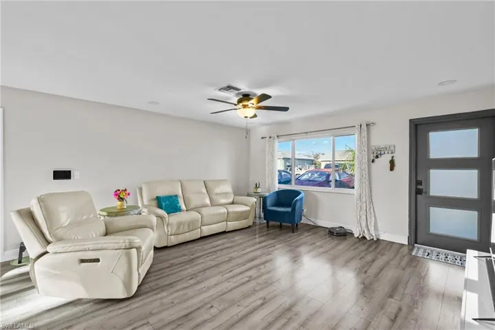 Living area featuring wood finished floors and ceiling fan