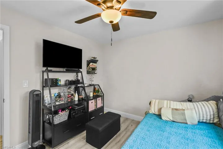 Bedroom with light wood finished floors and ceiling fan