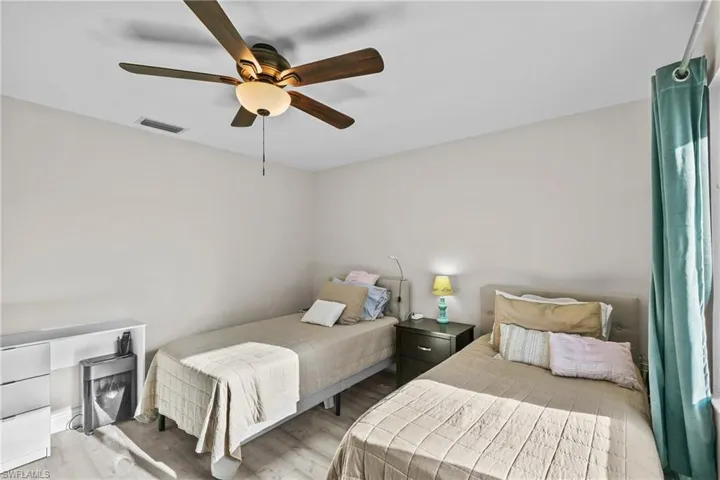 Bedroom with wood finished floors and ceiling fan