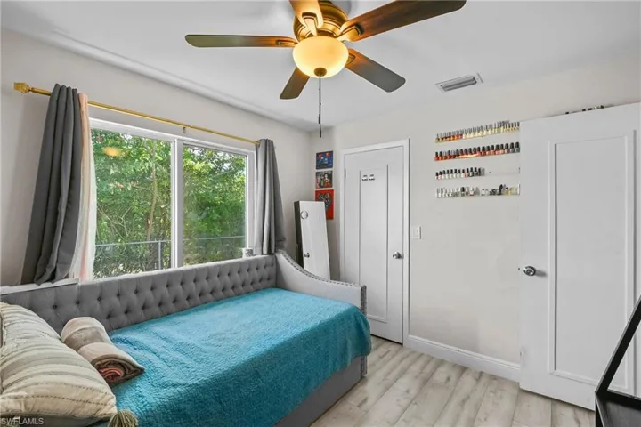 Bedroom with light wood finished floors and a ceiling fan