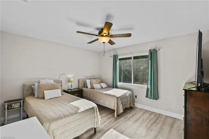Bedroom with light wood-style flooring and a ceiling fan