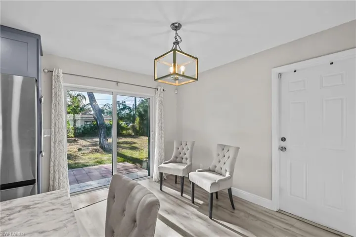 Dining area featuring light wood finished floors and a chandelier