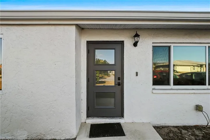 Doorway to property with stucco siding