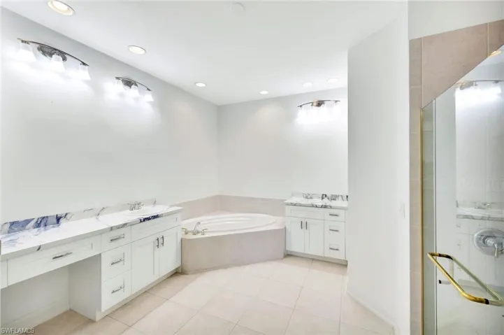 Bright and well-appointed primary Bathroom complete with dual sinks, makeup vanity, large soaking tub and separate walk-in Shower.