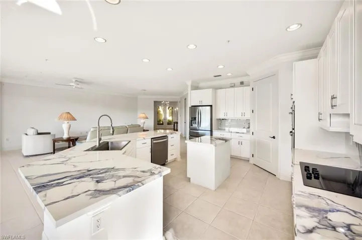 A spacious kitchen with convenient center island and walk-in pantry