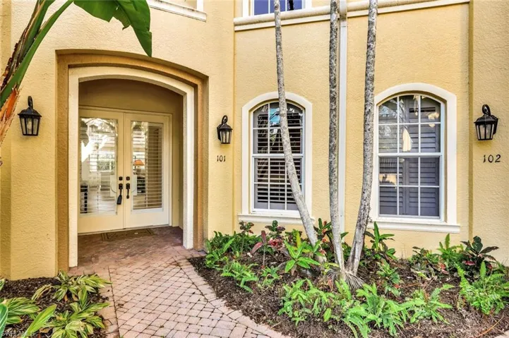 A brick-paver walkway leads to your double glass front door entry