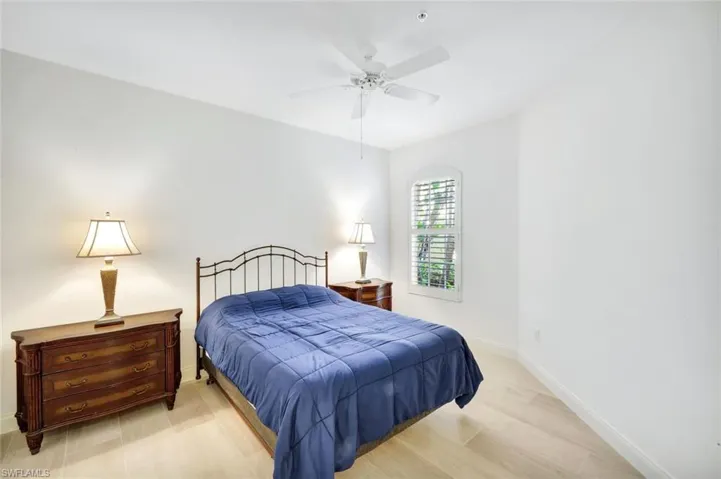 Generous Guest Bedroom with plantation shutters, ceiling fan and tile floors