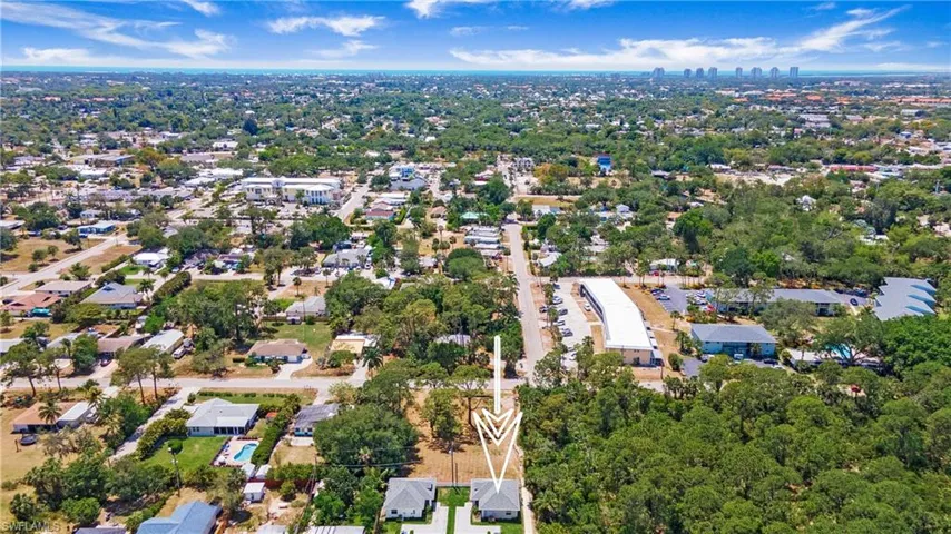 Aerial perspective showcasing two residential properties with light-colored roofs