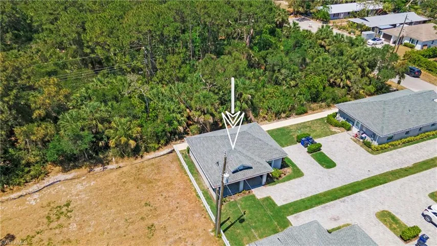 Single-story property featuring a gray shingle roof and light gray exterior