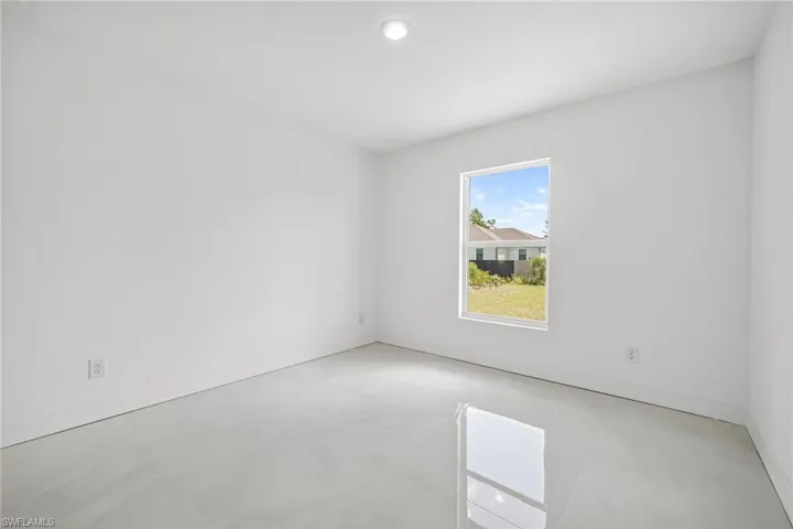 Unfurnished room with recessed lighting and baseboards