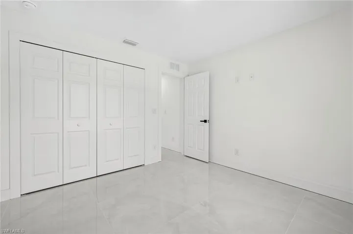 Unfurnished bedroom with light tile patterned floors and a closet