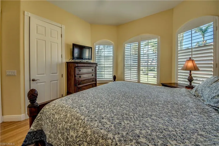 Bedroom with light wood-type flooring and multiple windows