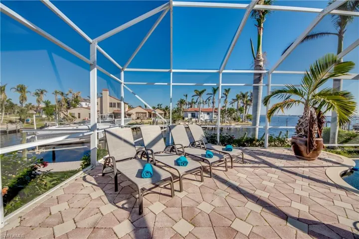 View of patio / terrace with a lanai and a water view