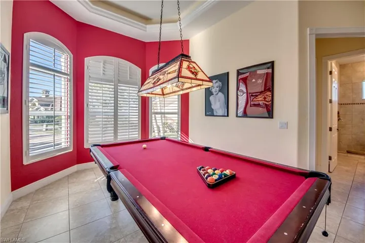 Game room with ornamental molding, billiards, a healthy amount of sunlight, and light tile patterned flooring