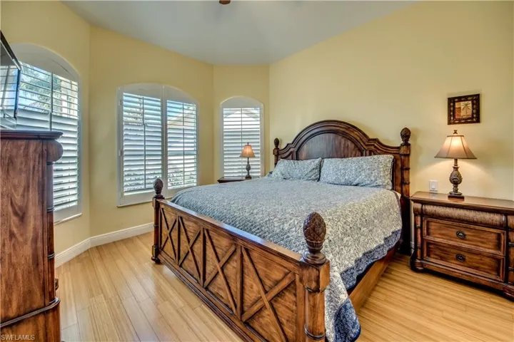 Bedroom featuring multiple windows and light hardwood / wood-style flooring