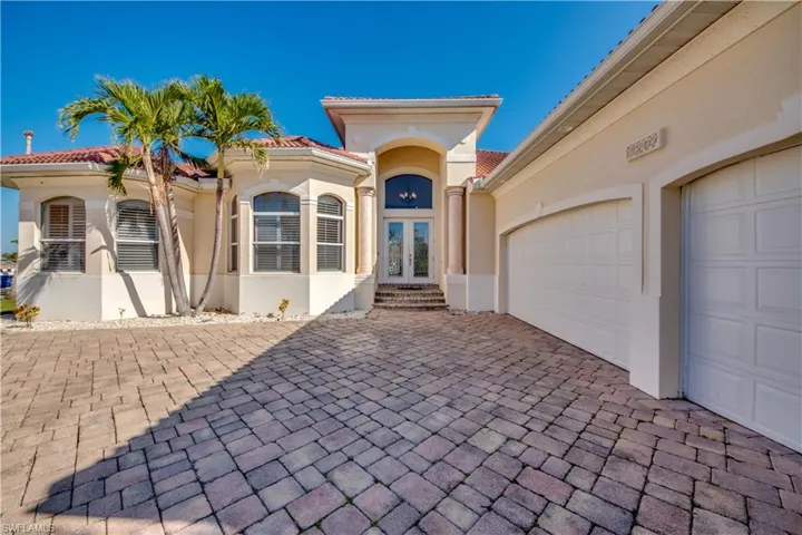 View of front of house featuring french doors and a garage