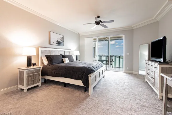 Bedroom featuring access to exterior, ornamental molding, light colored carpet, and ceiling fan
