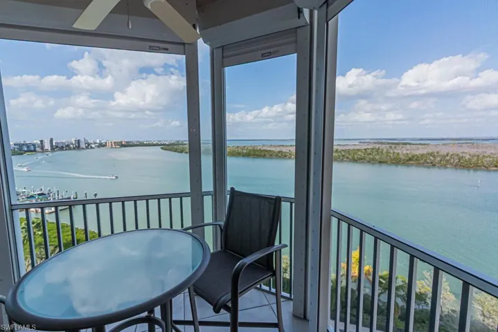 Balcony with a water view and a ceiling fan