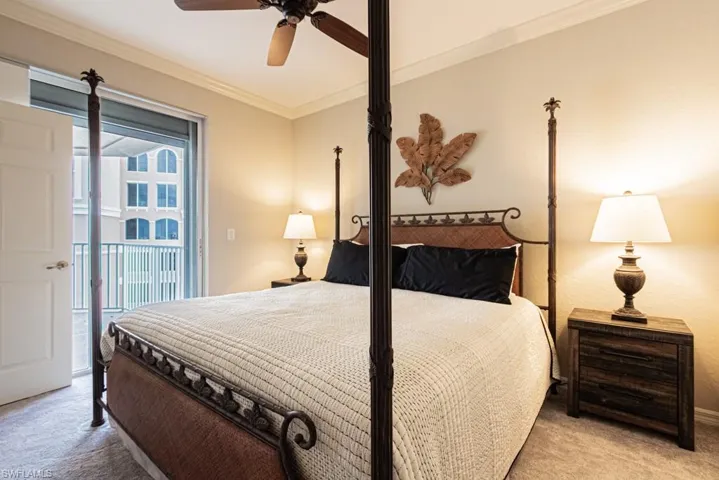 Carpeted bedroom featuring crown molding, a ceiling fan, and access to exterior