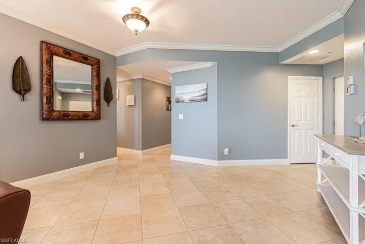 Unfurnished room featuring ornamental molding and light tile patterned floors