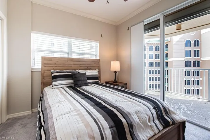 Bedroom with ornamental molding, carpet, ceiling fan, and access to outside