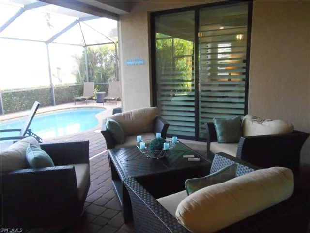 Swimming pool featuring outdoor lounge area, a patio area, a sunroom, and a lanai