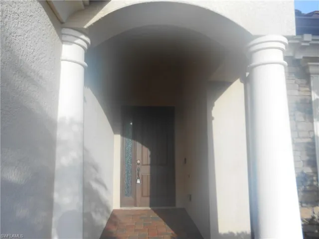 Doorway to property with stucco siding