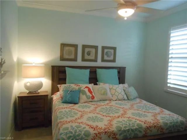 Bedroom with crown molding and ceiling fan