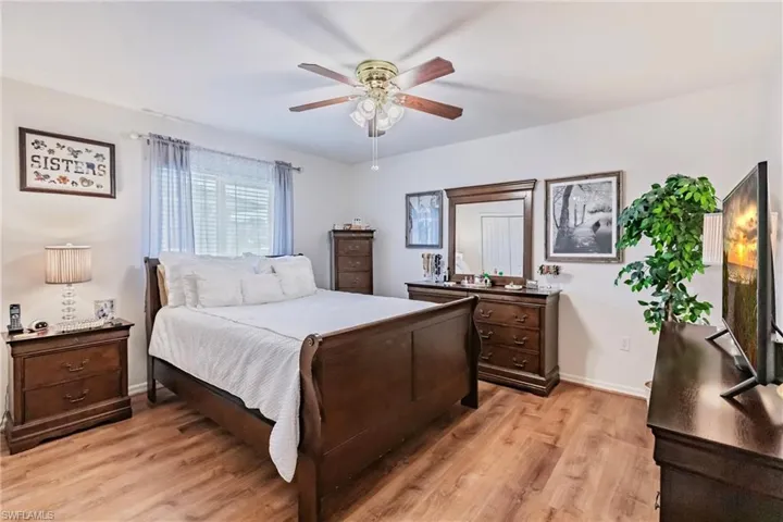 Bedroom with ceiling fan and light hardwood / wood-style flooring