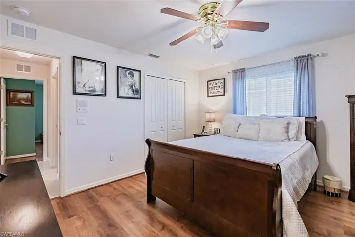 Bedroom featuring hardwood / wood-style flooring, a closet, and ceiling fan