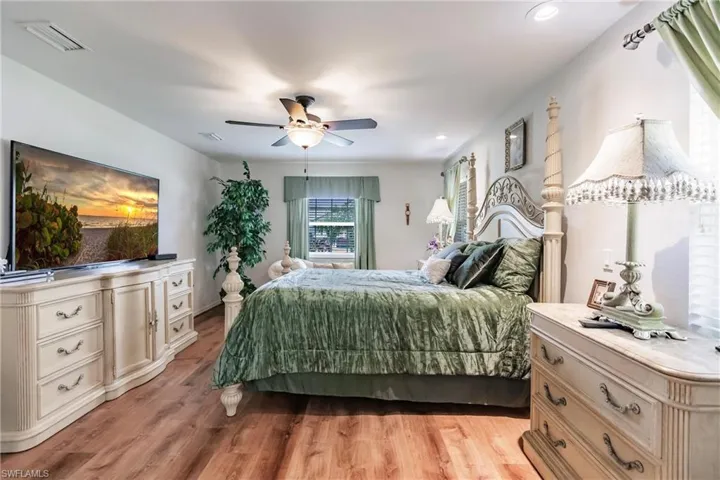 Bedroom with ceiling fan and light hardwood / wood-style flooring