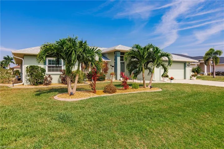 View of front facade with a garage and a front lawn