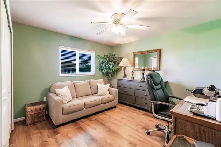 Office area featuring wood-type flooring and ceiling fan