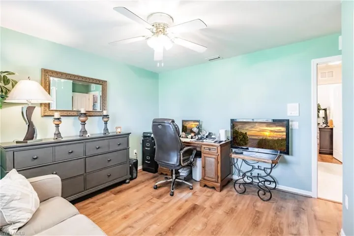 Office area with ceiling fan and hardwood / wood-style floors