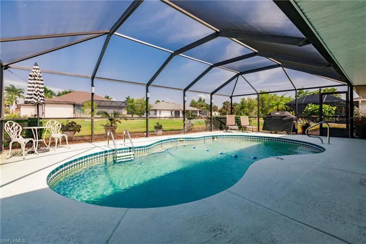 View of pool with a lanai and a patio