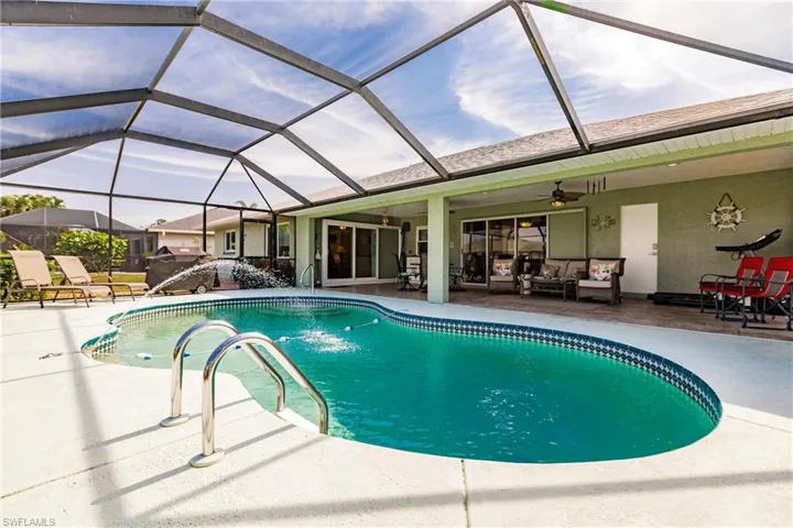 View of pool featuring a patio, a lanai, and ceiling fan