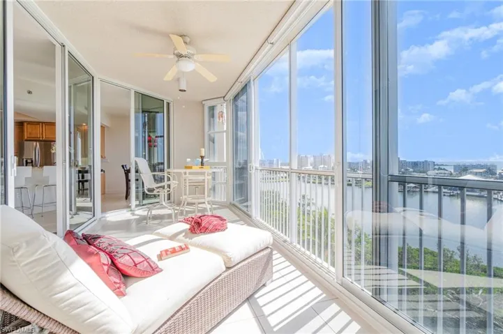 GLASS DOOR PANELS MAKE THE ROOM USABLE IN ALL TYPES OF WEATHER. EACH WINDOW ALSO HAS A ROLLER SHADE.  ENTRANCE TO LIVING AREA IS SHOWN THRU DOOR AT LEFT.  CONVENIENT KITCHEN ACCESS IS SHOWN AT MIDDLE REAR.