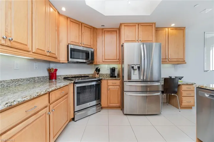 BRAND NEW STAINLESS STEEL MICROWAVE AND DISHWASHER.  GRANITE COUNTERTOPS WITH FULL-HEIGHT TILED BACKSPLASH.  UNDER-CABINET LIGHTING.  RECESSED LIGHTING. BUILT-IN DESK.  COFFERED CEILING DETAIL.