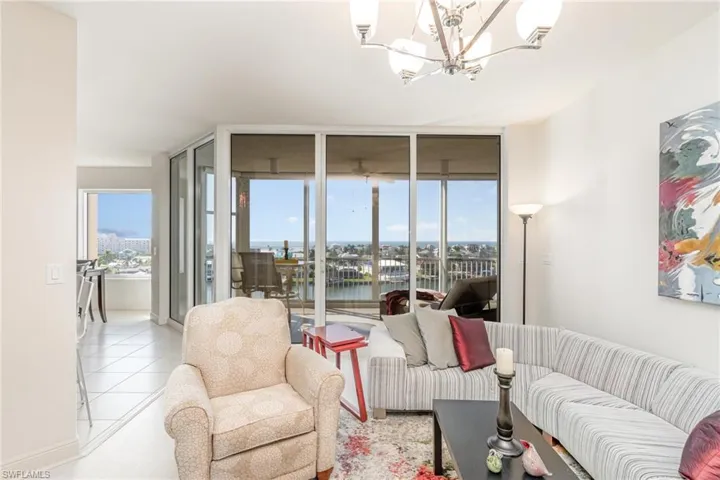 MAIN LIVING AREA WITH BUCCANEER LAGOON AND GULF VIEWS.  NEARLY A WALL OF SW/W EXPOSURE VIEWS.