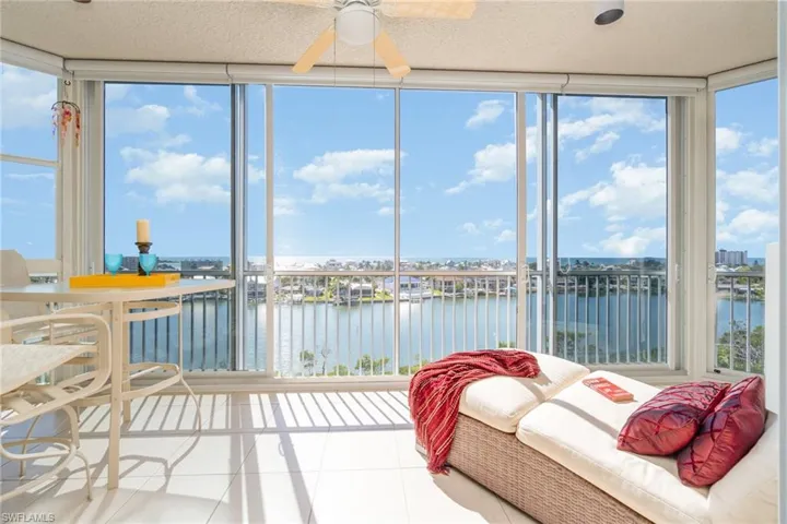 SPARKLING GULF OF MEXICO AND BUCCANEER LAGOON VIEWS.   GLASS DOOR PANELS MAKE THE ROOM USABLE IN ALL TYPES OF WEATHER. EACH WINDOW ALSO HAS A ROLLER SHADE.