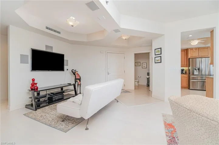 MAIN LIVING AREA FEATURING ENGINEERED HARDWOOD FLOORING.  UNIT ENTRANCE SHOWN AT MIDDLE REAR.NOTE COFFERED CEILING DETAILS THROUGHOUT UNIT.