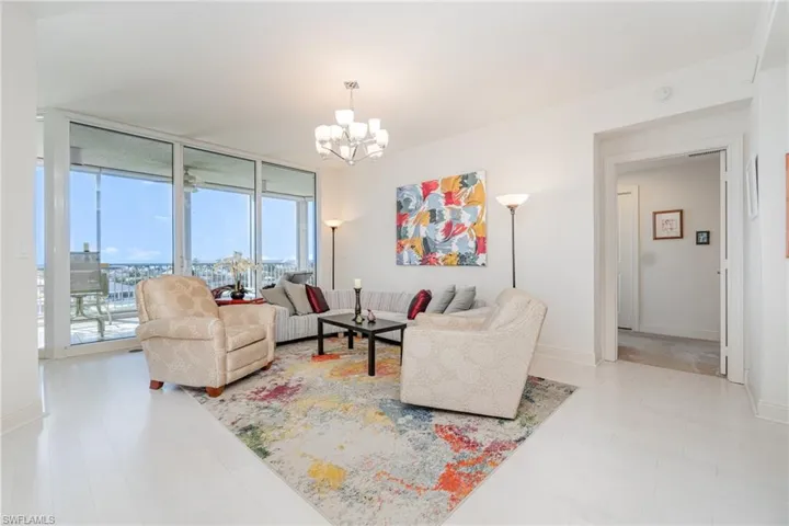 BRIGHT AND AIRY MAIN LIVING AREA.  ENGINEERED HARDWOOD FLOORING. ENTRANCE TO OWNER'S SUITE SHOWN.