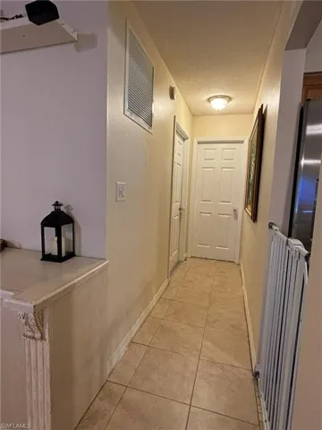 Hallway to Primary Bedroom And Laundry Room And Garage