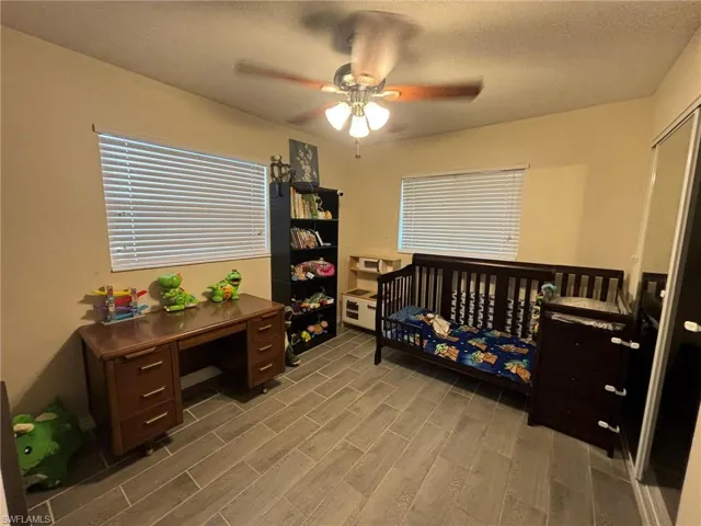 Guest Bedroom with tile floors and ceiling fan