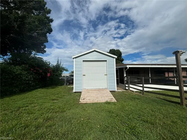 View of outbuilding with a yard